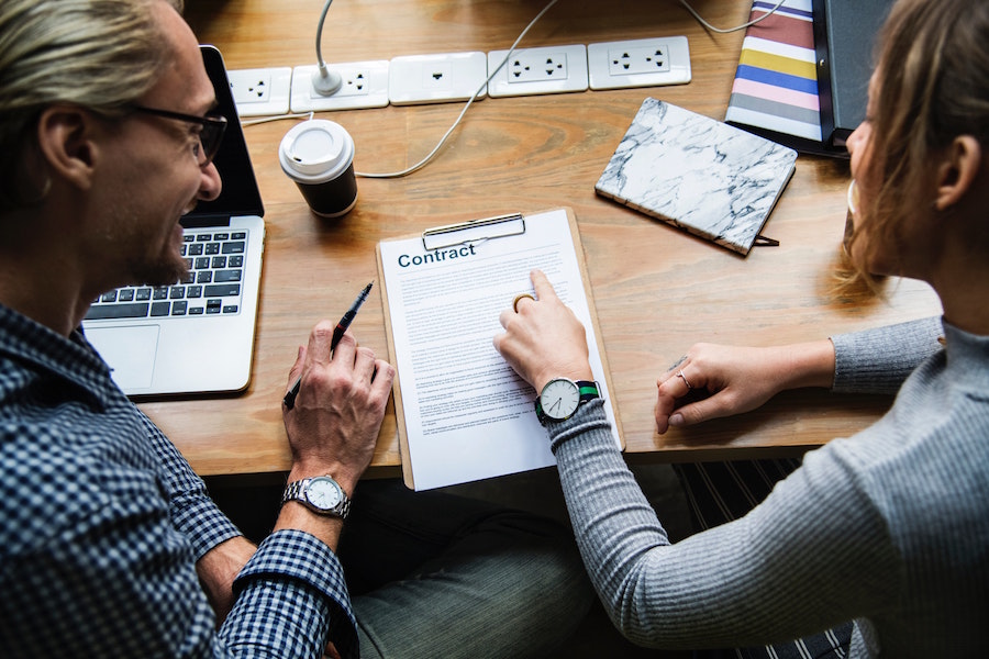 Agent and client looking over a contract