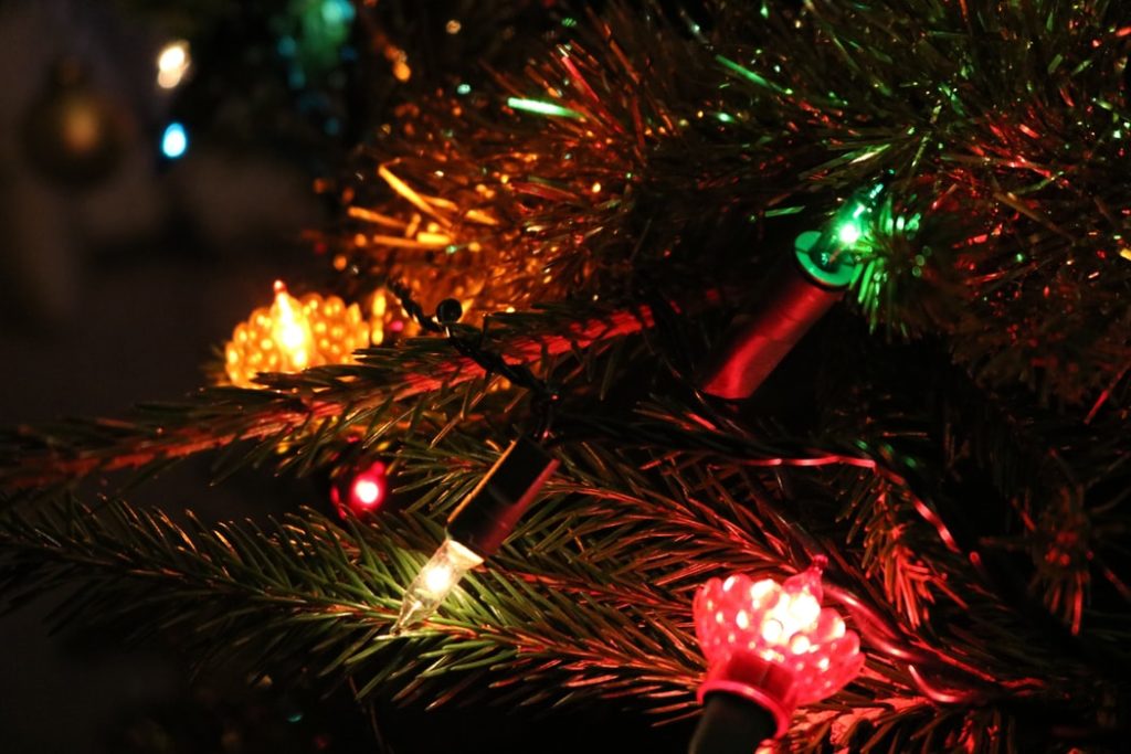 A Christmas tree with lights on it at a holiday event.